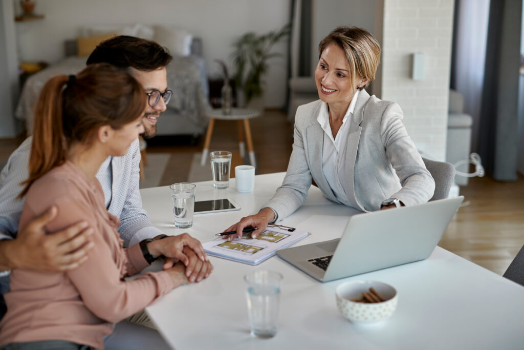 Letting agent discussing property details with tenants inside a rental home, representing Woking landlord advice, rental yields and property management.
