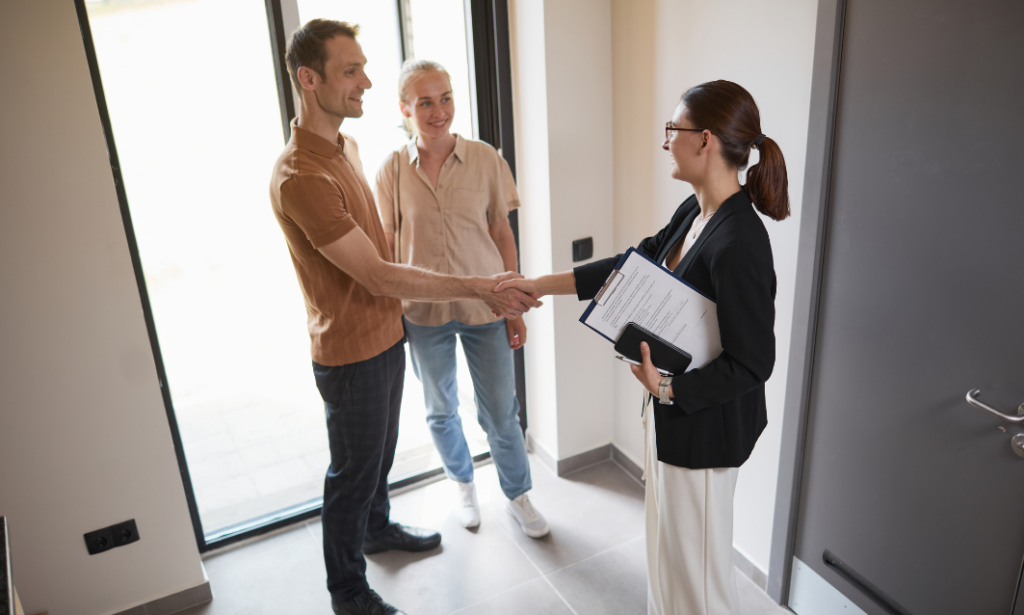 A letting agent welcoming new landlords during a property handover and discussing Private Residential Tenancy compliance in Aberdeen.