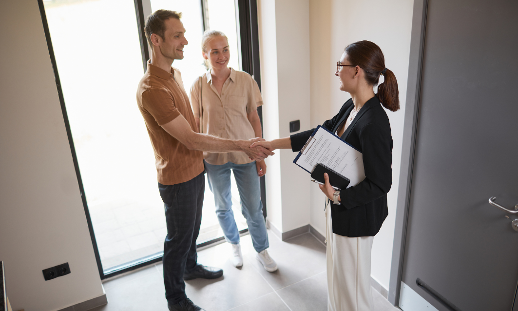 A letting agent welcoming new landlords during a property handover and discussing Private Residential Tenancy compliance in Aberdeen.