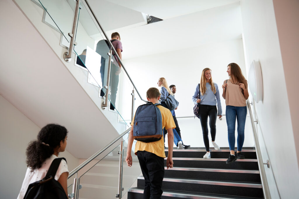 Students walking through a modern school building, reflecting the impact of Paisley’s new Grammar School Campus on local property demand and family buyers.
