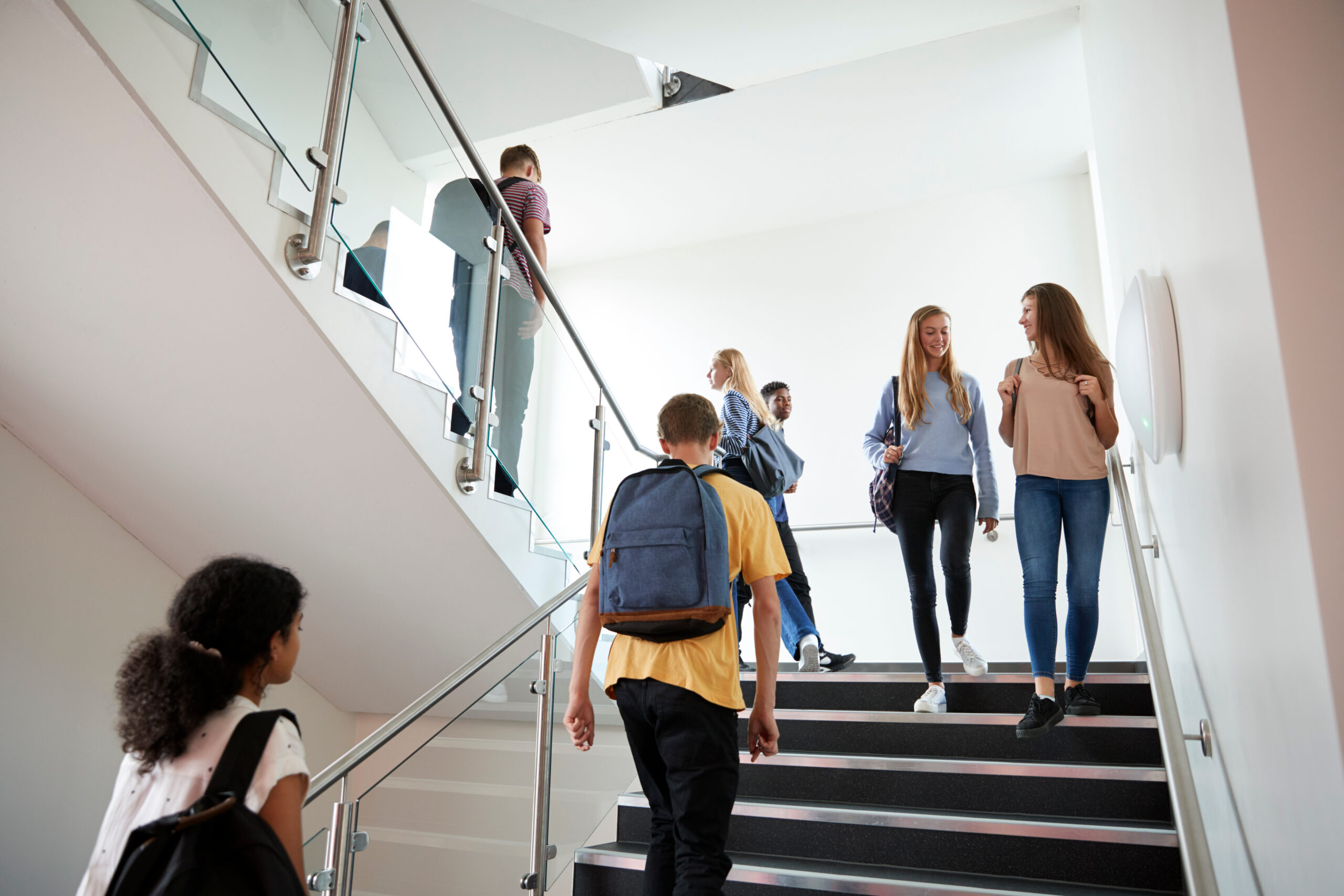 Students walking through a modern school building, reflecting the impact of Paisley’s new Grammar School Campus on local property demand and family buyers.