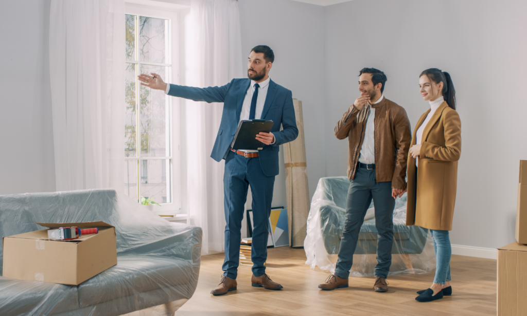 A letting agent showing a rental property to a couple during a viewing in Westbury, Wiltshire.