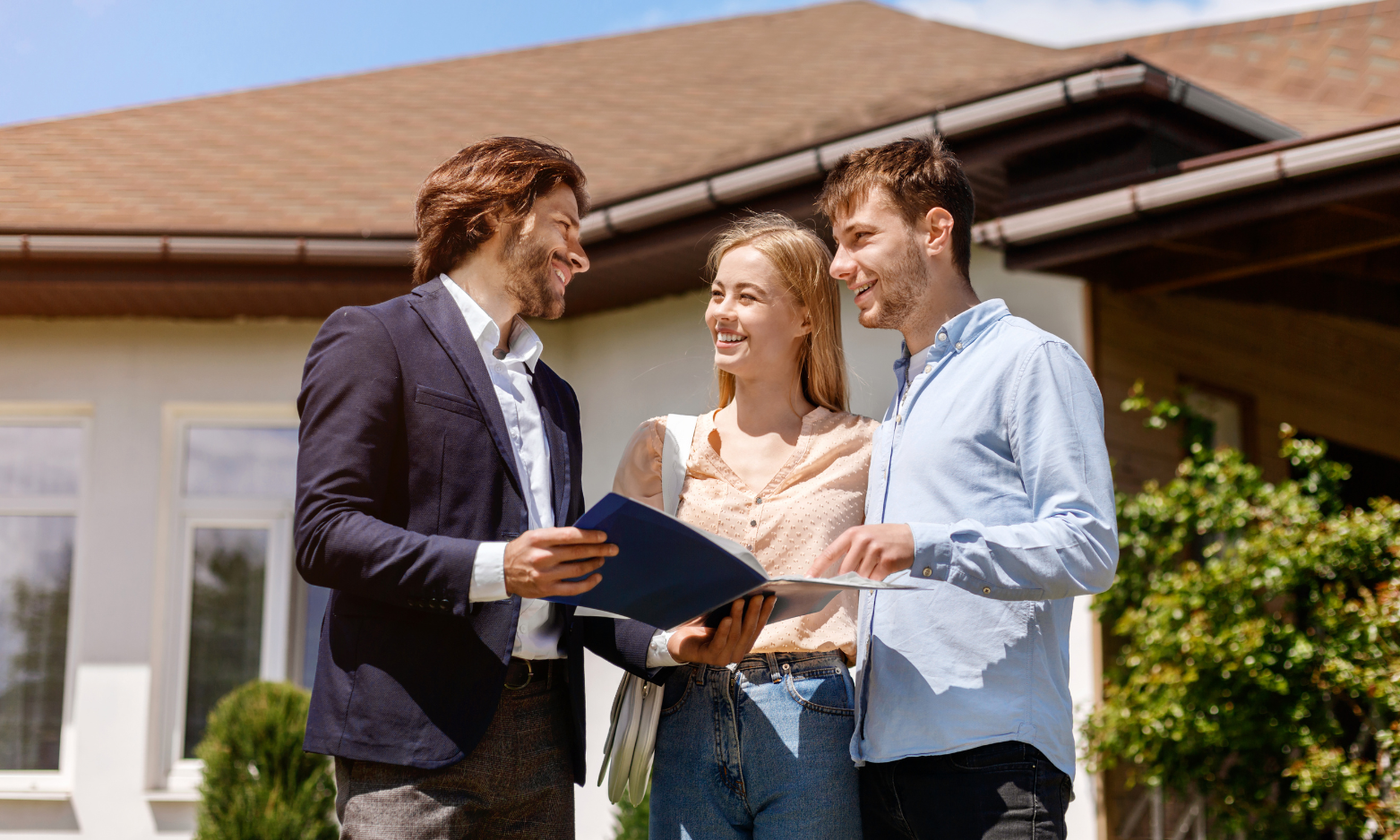 A landlord or letting agent discussing a rental property with prospective tenants outside a modern home in Stoke-on-Trent.