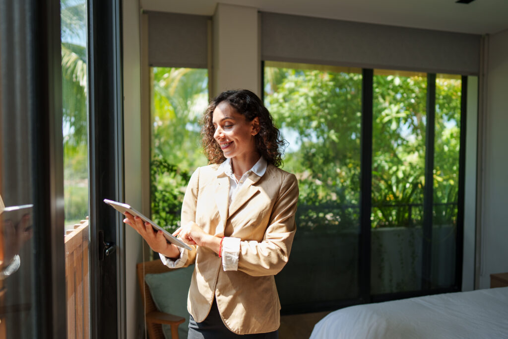 Estate agent using a tablet inside a bright property, reflecting market appraisal, selling advice and property guidance for Southampton homeowners.