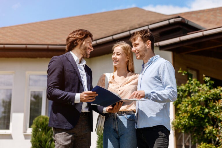 Estate agent speaking with a couple outside a property, reflecting selling advice and local market guidance for homeowners in Stoke-on-Trent.