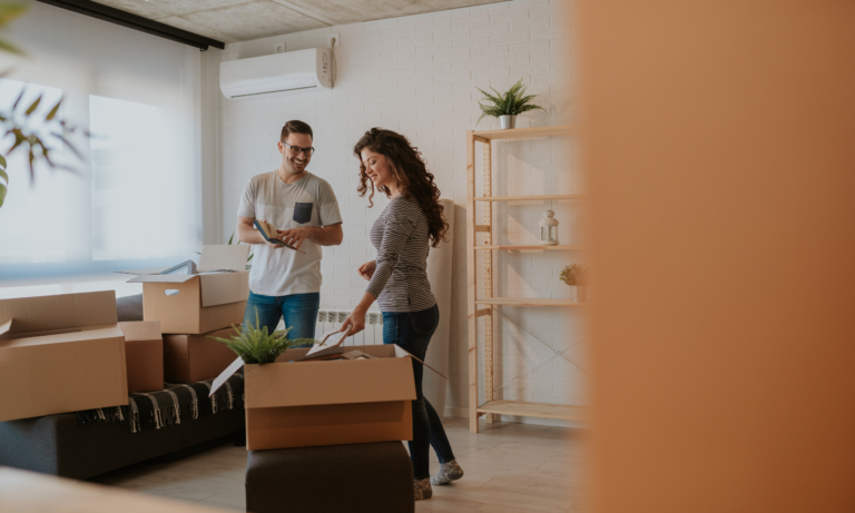 A couple unpacking boxes in a new home while planning their move in Leamington Spa.