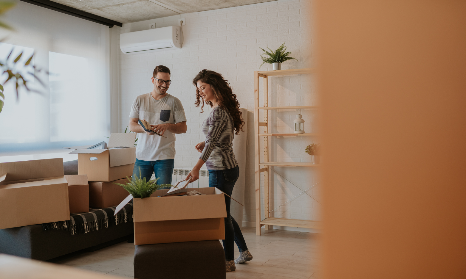 A couple unpacking boxes in a new home while planning their move in Leamington Spa.