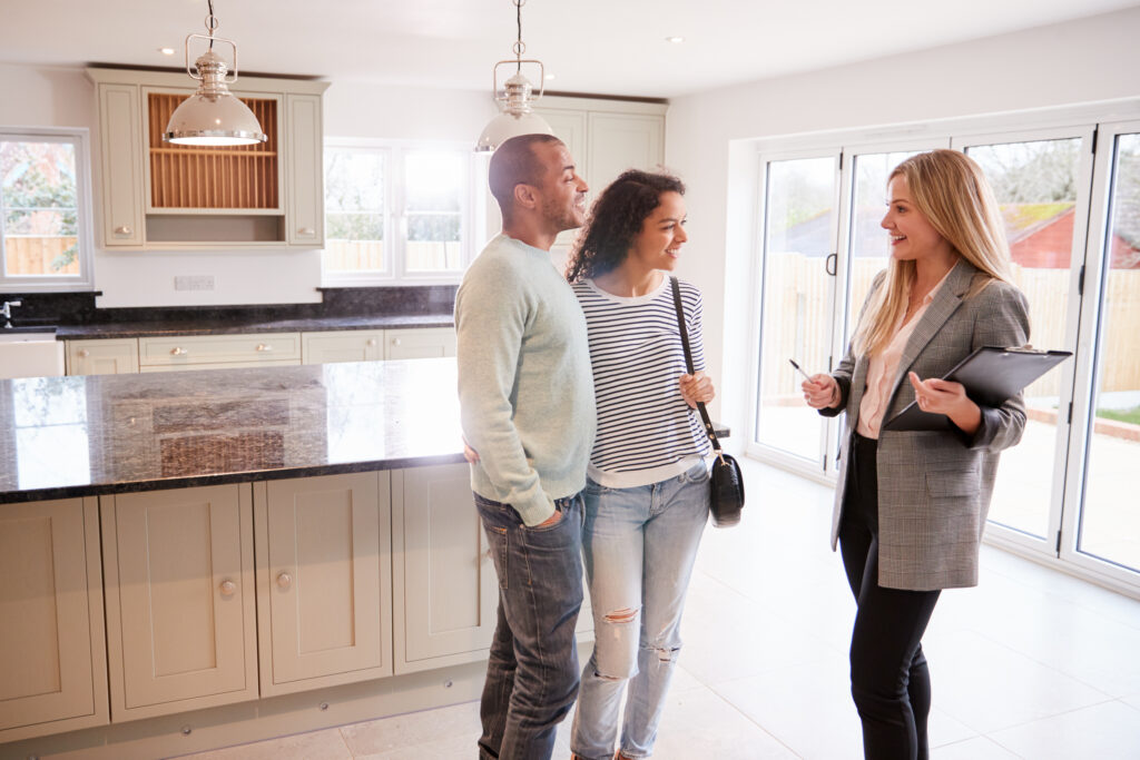 Estate agent showing a couple around a bright kitchen, reflecting landlord compliance, tenant management and rental guidance under the Renters’ Rights Act in Woking.
