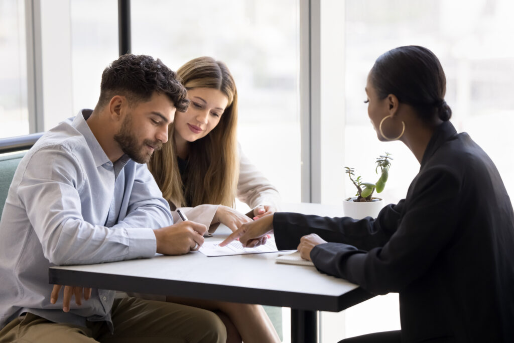 Property investors discussing a buy-to-let agreement with a property professional in Birmingham.