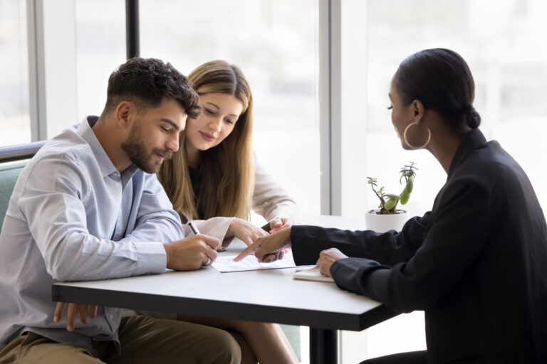 Property investors discussing a buy-to-let agreement with a property professional in Birmingham.