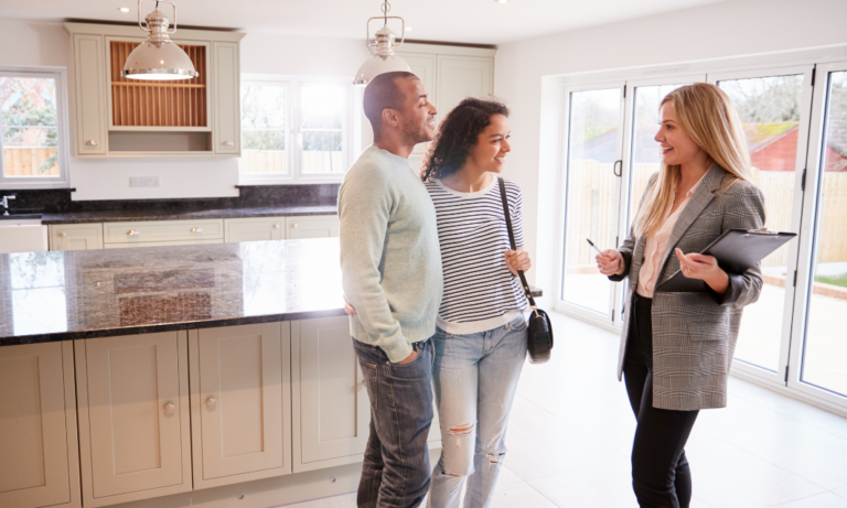 A couple viewing a modern home with an estate agent in Alloway, Ayr.