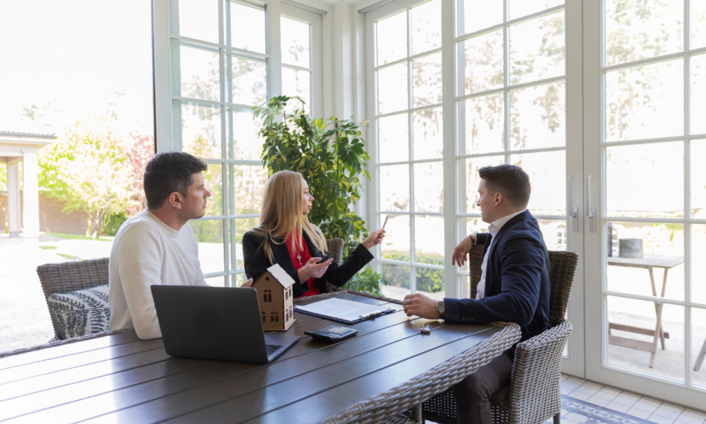 Property buyers discussing a new build apartment with an estate agent in Woking.