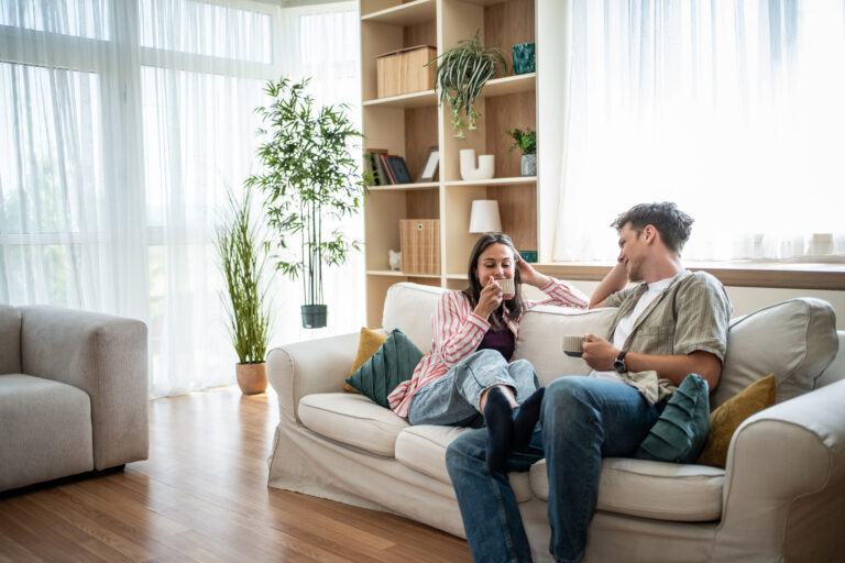 Young couple relaxing in a bright modern rental home in Woking.