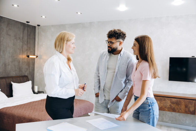 Landlords discussing rental property requirements with a letting agent during a property visit in Ayr.