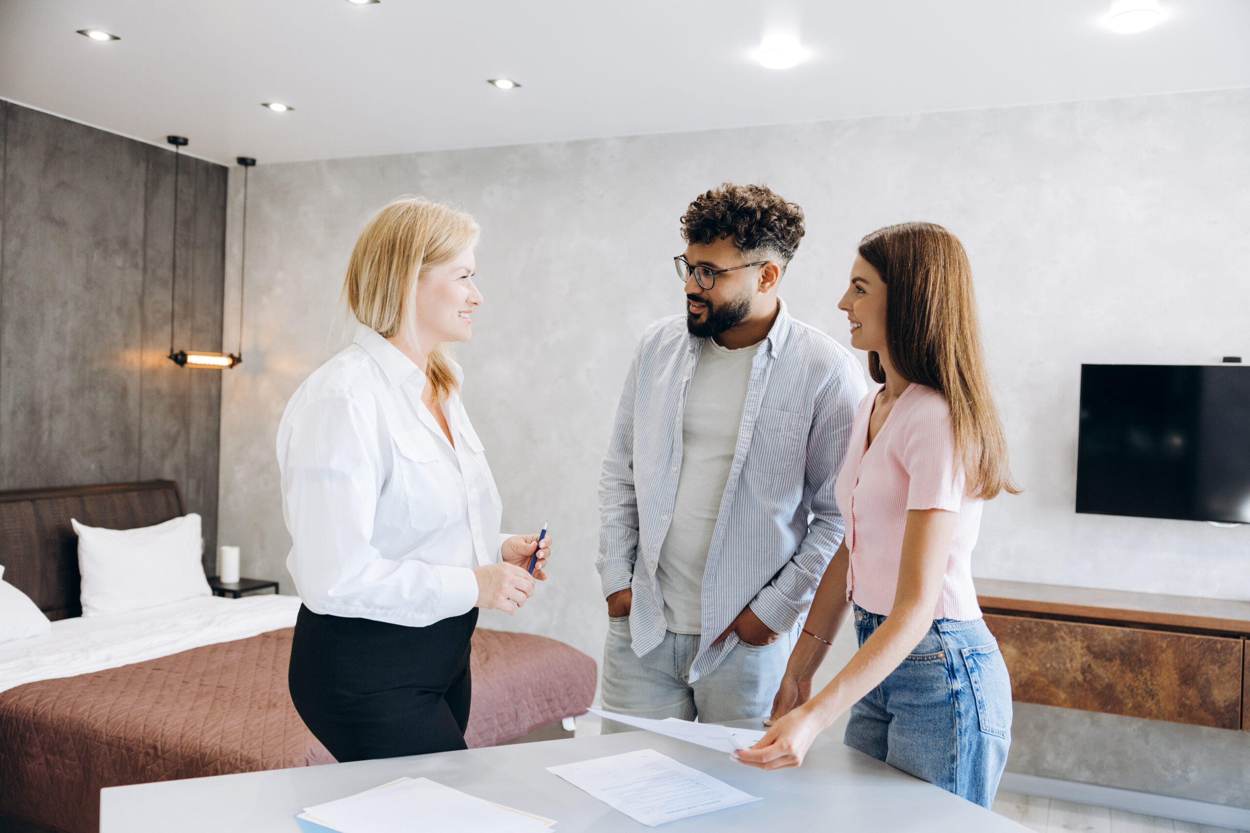 Landlords discussing rental property requirements with a letting agent during a property visit in Ayr.