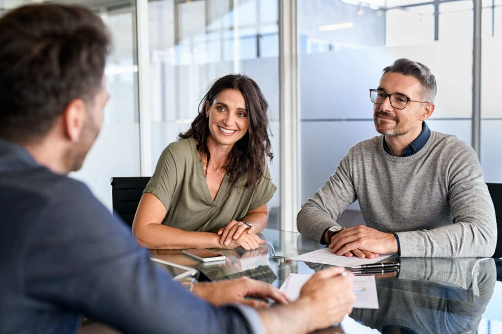 Homeowners meeting with a property professional to discuss selling their home in Aberdeen.