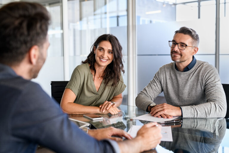 Homeowners meeting with a property professional to discuss selling their home in Aberdeen.
