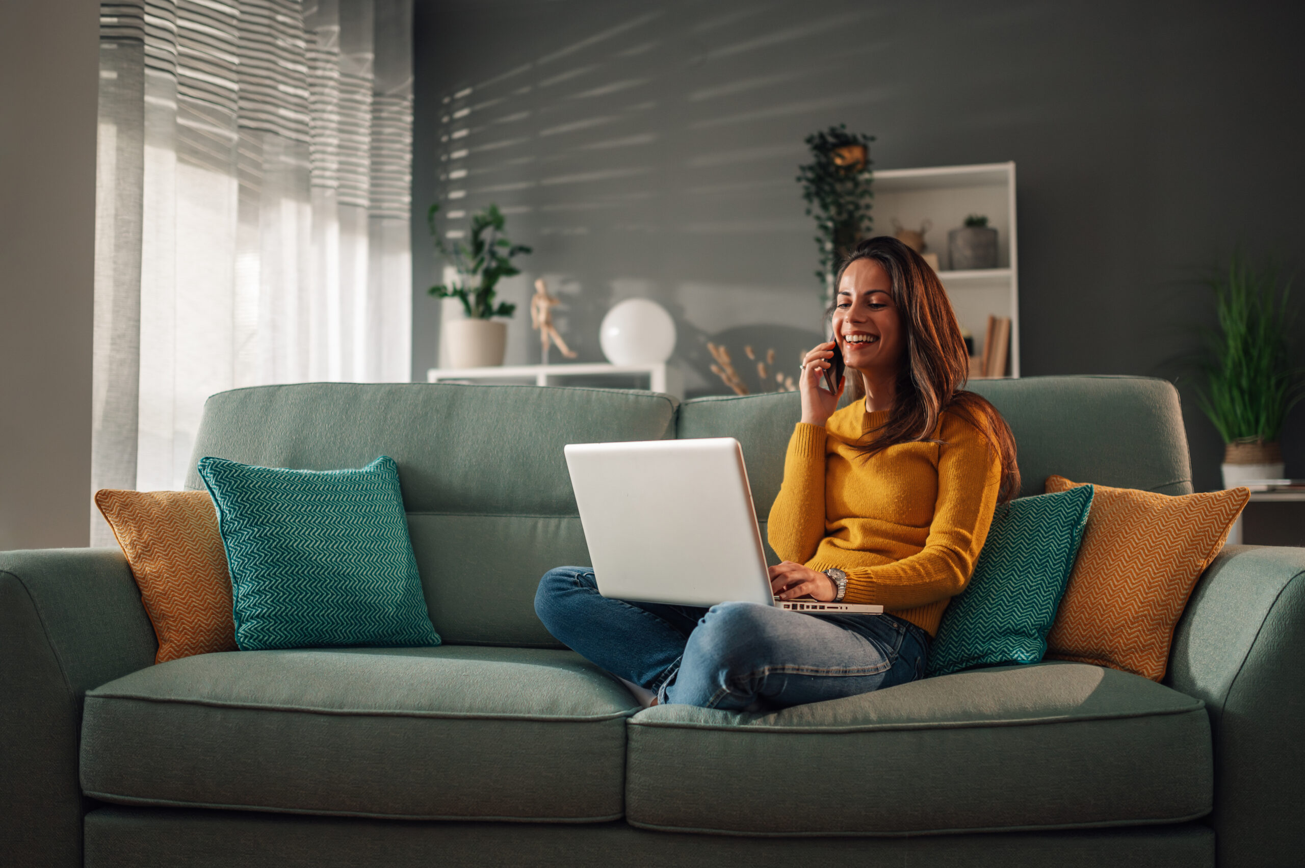 Homeowner speaking with an estate agent by phone while researching the St Ninians property market before selling a home.