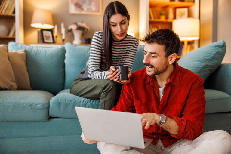 Homeowners reviewing property information online while preparing to sell their home in Dunfermline.