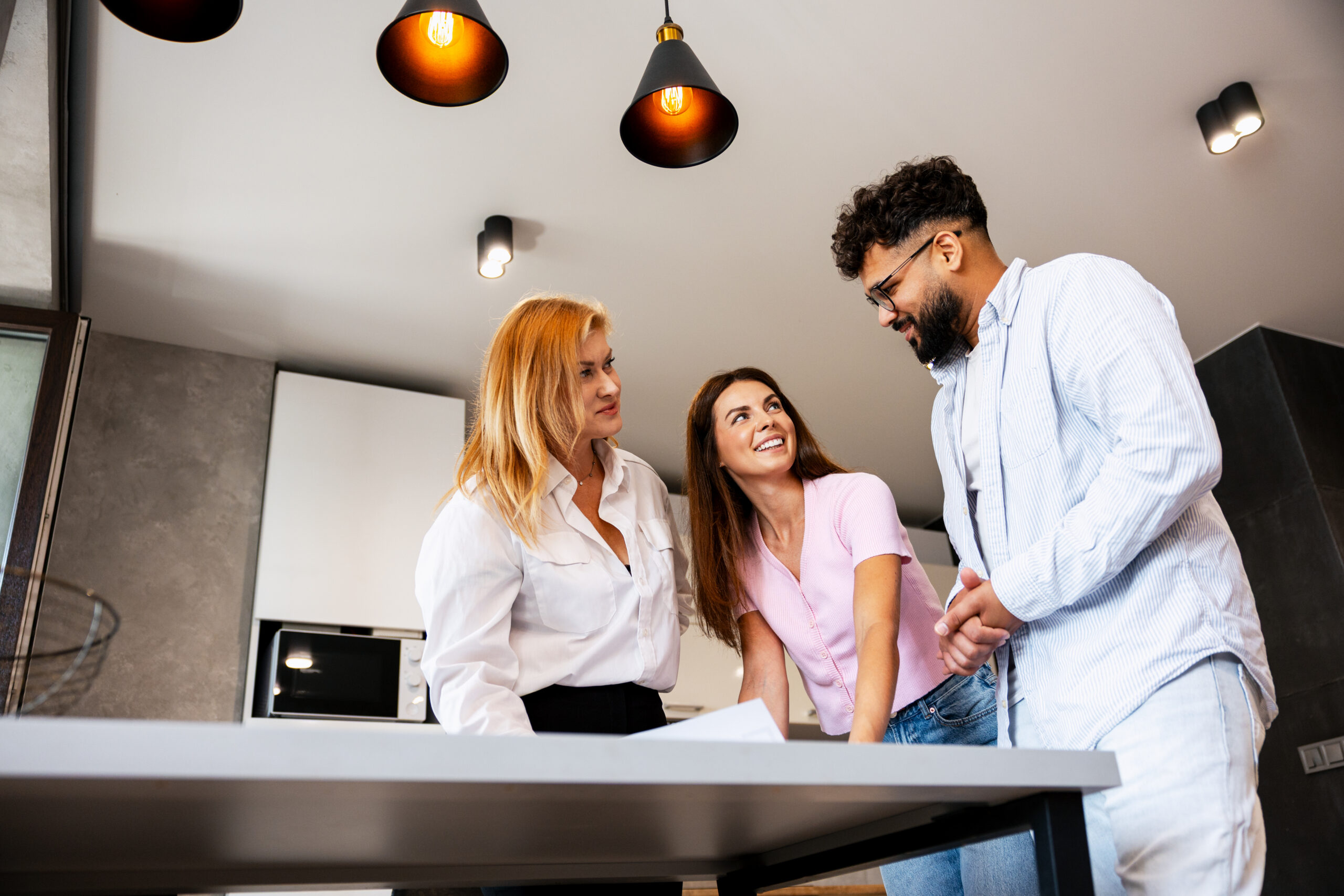 Estate agent discussing property details with a couple during a home valuation in Stoke-on-Trent.