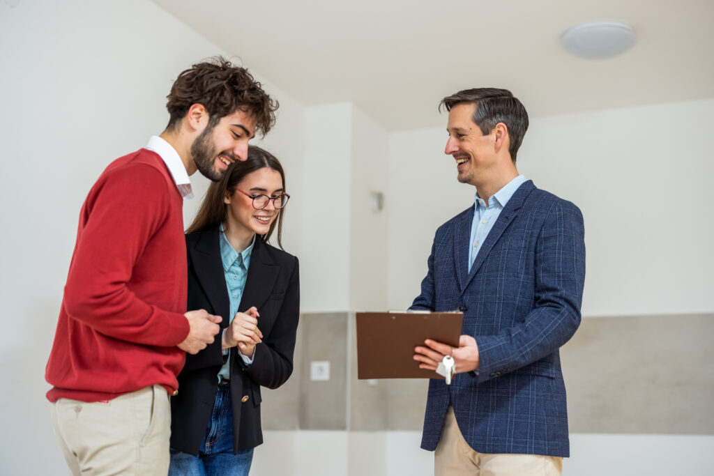 Estate agent discussing property details with a couple during a home viewing in Woking.
