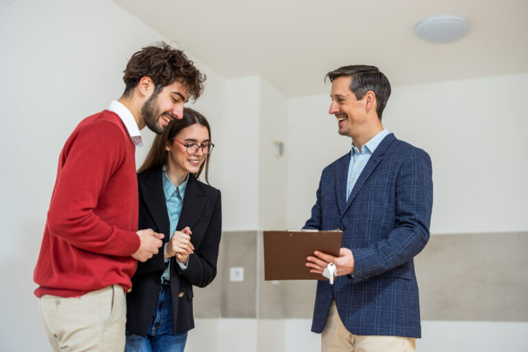 Estate agent discussing property details with a couple during a home viewing in Woking.