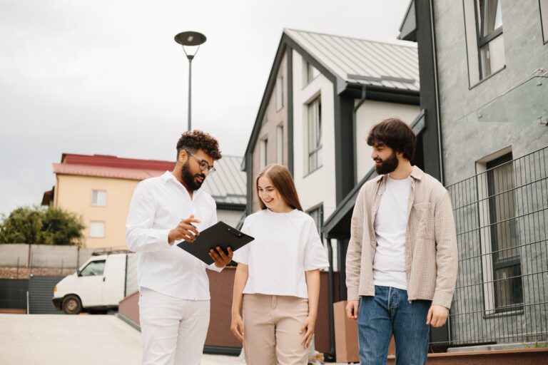 Landlords reviewing property compliance requirements with a letting agent in Cardiff.