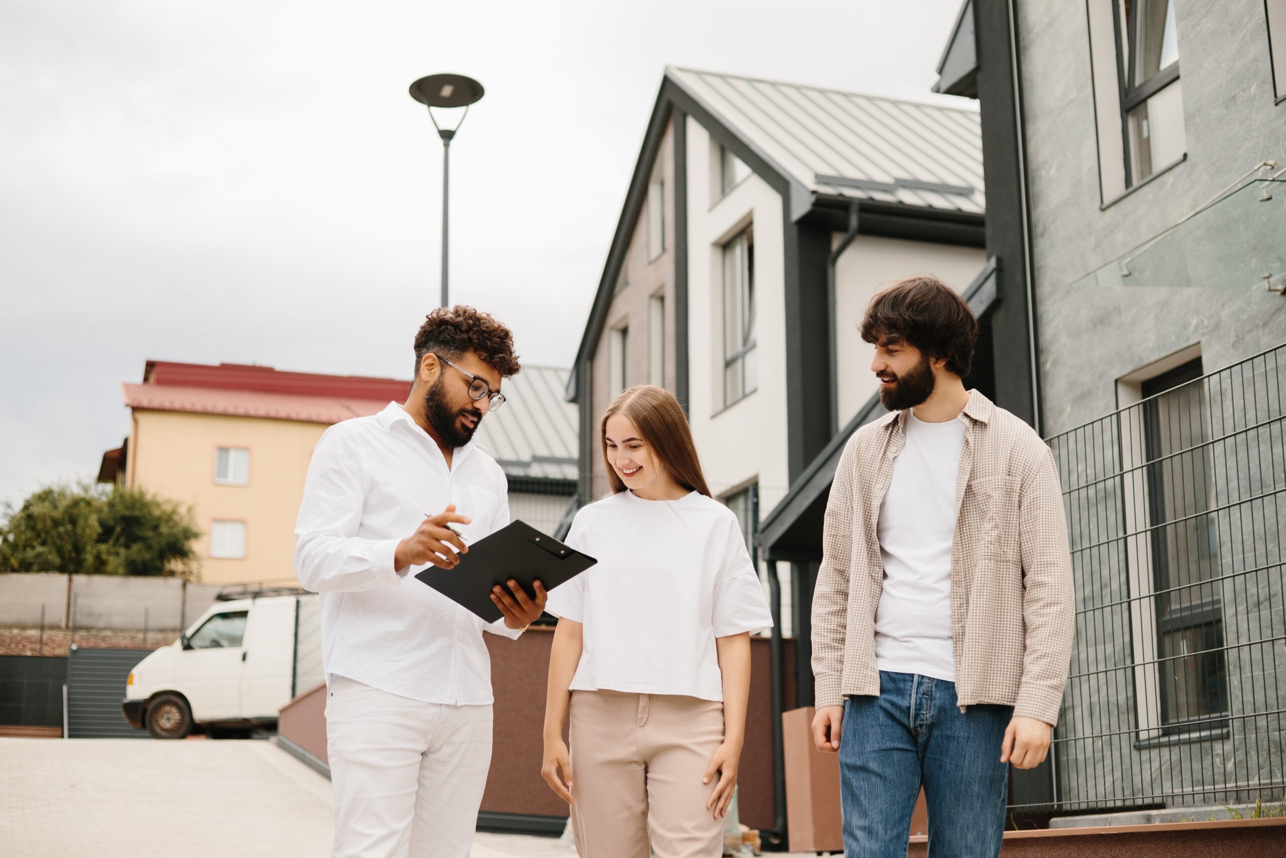 Landlords reviewing property compliance requirements with a letting agent in Cardiff.