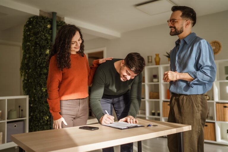 Tenant signing property paperwork with an estate agent