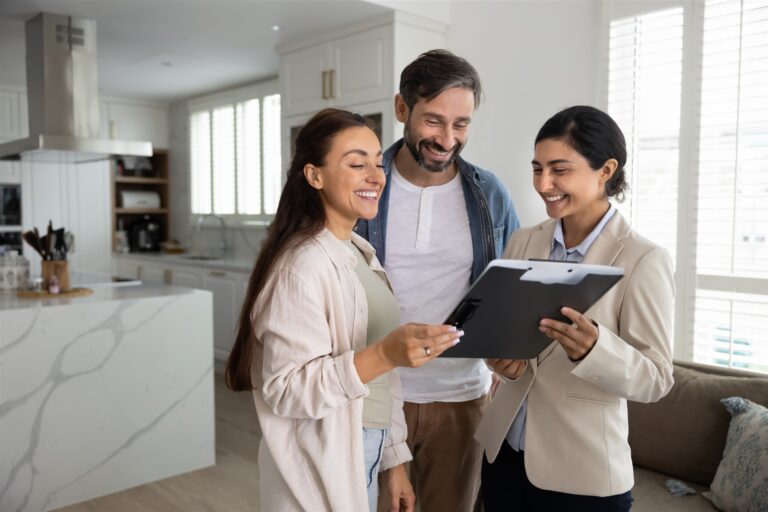 Estate agent discussing property documents with a couple