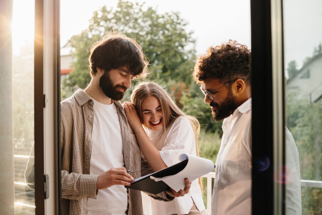 Estate agent reviewing property paperwork with home buyers