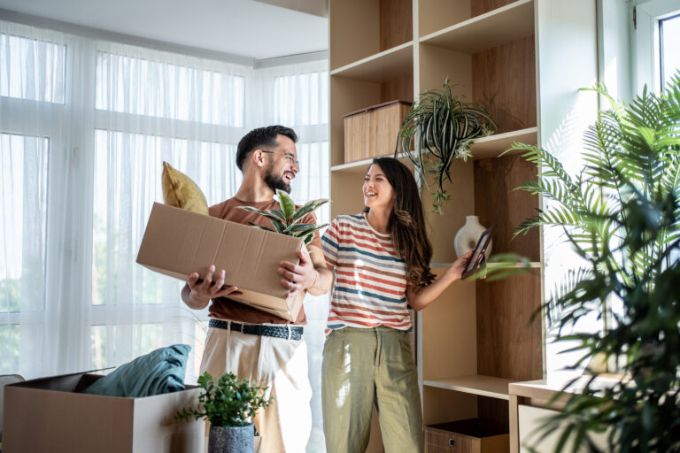 Couple unpacking a box after moving into a new home