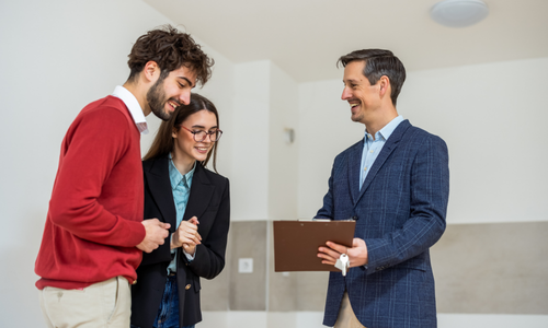 Couple speaking with an estate agent while viewing a property in Battenhall, Worcester