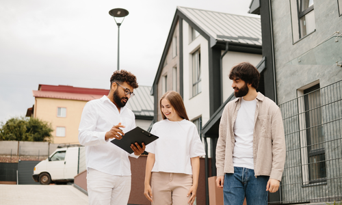 Couple viewing a modern property with an estate agent in Hanley, Stoke-on-Trent