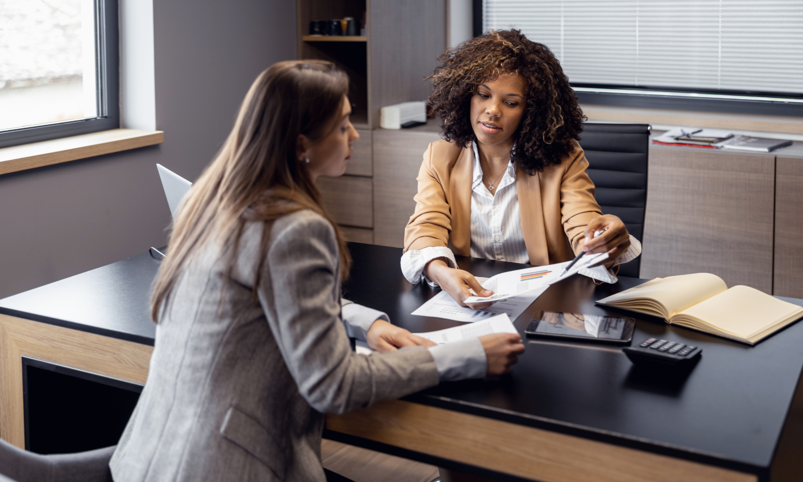 Property professional discussing investment documents with a client