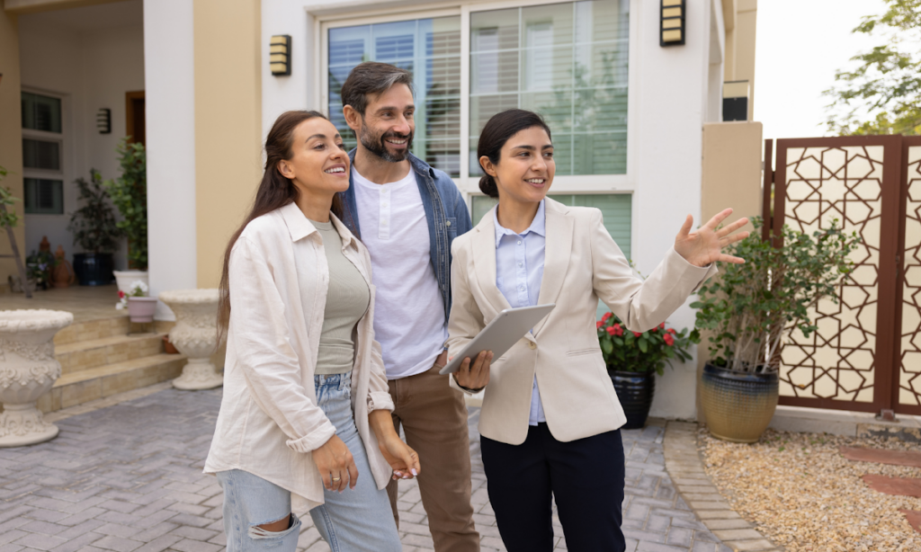 Estate agent showing a couple around a modern home