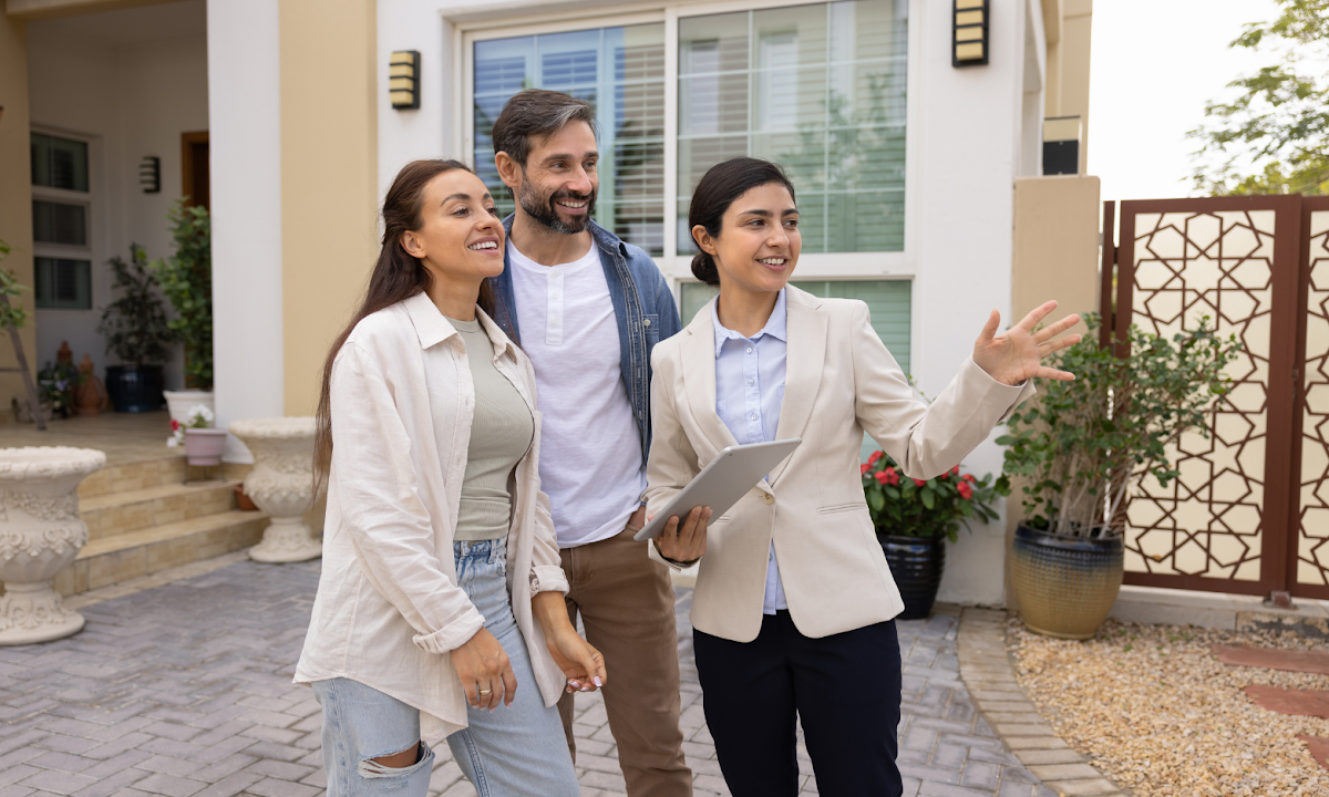 Estate agent showing a couple around a modern home