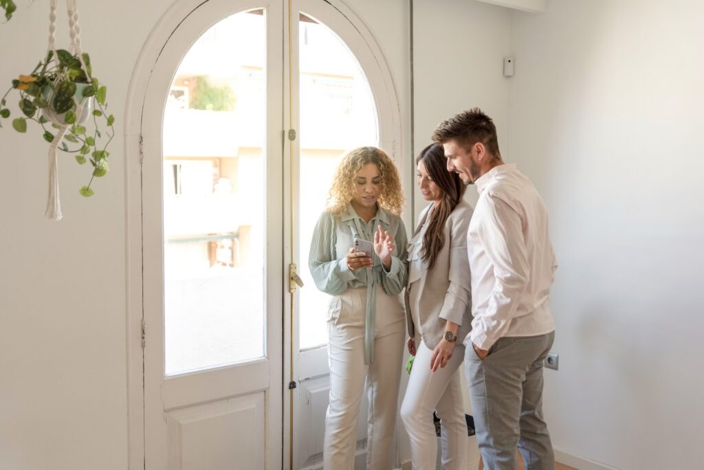 Estate agent showing a period home to buyers in Leamington Spa