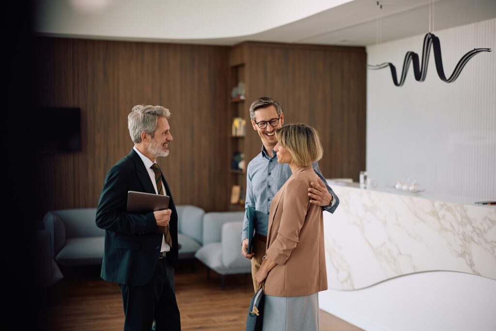 Estate agent discussing a flat purchase with buyers in Woking